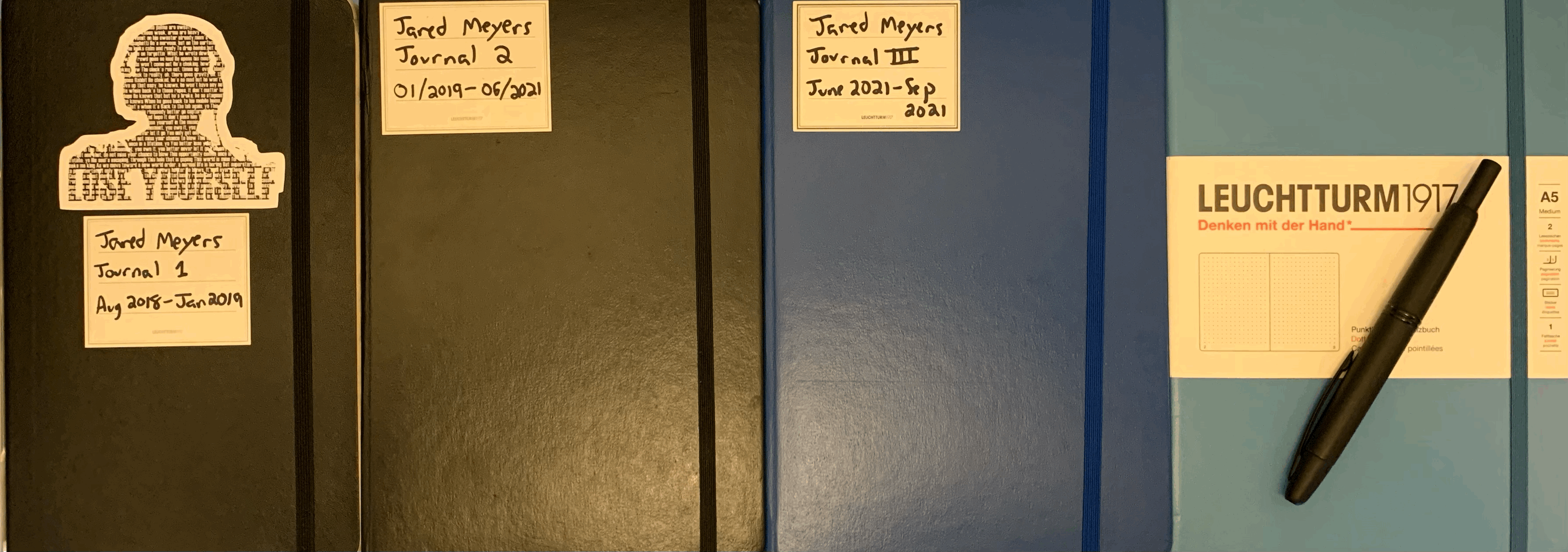 Image of four notebooks, each a journal completed by the author.